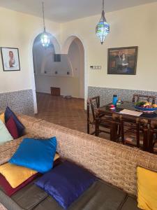 a living room with a couch and a table at Atlantic Vacation villa in Dar Oulad Hajj Kassem
