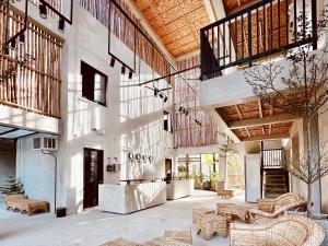 a large room with tables and chairs in a building at Rucksack Inn Siargao in General Luna
