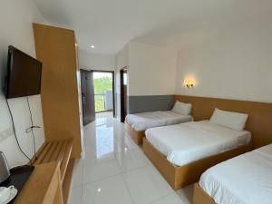 Postel nebo postele na pokoji v ubytování Morib Prosper Resort by uBook + 33 fotografií