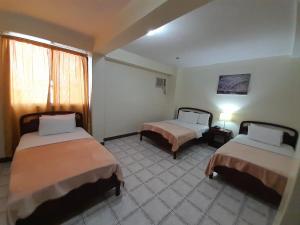 Postel nebo postele na pokoji v ubytování Hotel Cisne II