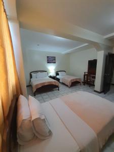 Postel nebo postele na pokoji v ubytování Hotel Cisne II