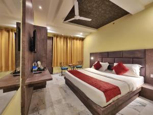 a bedroom with a large bed with red pillows at The White Orchid Dalhousie in Dalhousie +56 photos