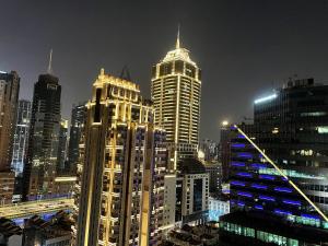 a city skyline with tall buildings at night at 上海柠檬汁民宿 Shanghai lemon juic B&B-Shanghai Lemon Deluxe Room 外滩南京西路步行街 in Shanghai