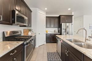 a kitchen with wooden cabinets and stainless steel appliances at Fun in the Sun Retreat home in Washington