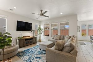 a living room with a couch and a flat screen tv at Fun in the Sun Retreat home in Washington +34 photos