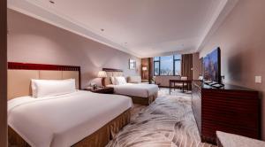 Voodi või voodid majutusasutuse Wuhan Hongguang Hotel toas
