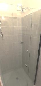 a shower with a glass door with a sink at Apartamento Aeropuerto Rionegro in Rionegro