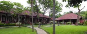 a house with a lawn in front of it at Reef Seen Divers' Resort in Pemuteran