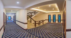 a hallway with a staircase in a house at Hotel Zomday in Leh