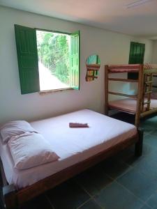a bedroom with a bed and a window and a bunk bed at Velho Testamento in Lençóis +28 photos