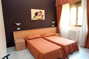 En eller flere senge i et værelse på Hotel Bicocca