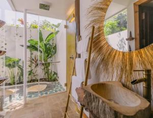a bathroom with a wooden tub and a mirror at La Fontaine de Tara in Siem Reap +58 photos