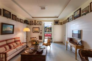 a living room with a couch and a table at Yacht Club Capo Cervo Suites B&B in Sorrento