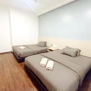 Postel nebo postele na pokoji v ubytování Rg Hotel Ayer Hitam