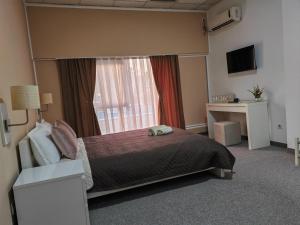 Postel nebo postele na pokoji v ubytování Aparthotel Waldinger Skopje