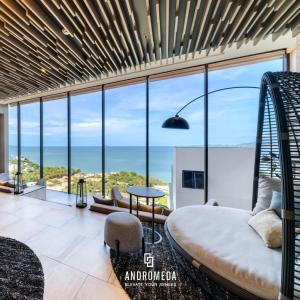 a bedroom with a bed and a view of the ocean at Exclusive High Floor 2 Bed Room Sea View Luxury in Pattaya South