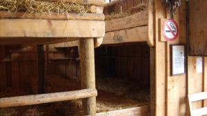 a barn with a no feeding sign and hay at Steigmatt Bauernhof- Erlebnis in Montlingen