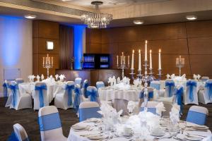 a banquet room with white tables and blue chairs at Park Inn by Radisson Palace in Southend-on-Sea
