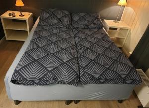 a large bed in a small room with two tables at Holidays 4 rooms in Gol