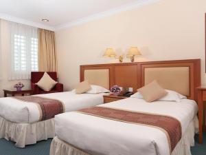 Postel nebo postele na pokoji v ubytování Hotel Sentosa