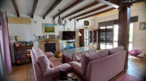 a living room with two couches and a table at Casa Victoria in Arcos de la Frontera