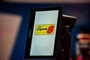 a cell phone with a super sign on it at Super 8 by Wyndham Biloxi in Biloxi