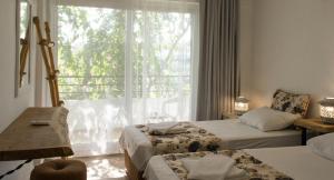 Postel nebo postele na pokoji v ubytování Pataros Hotel