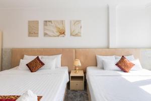 Postel nebo postele na pokoji v ubytování Nghia Lan Hotel
