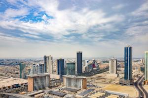 an aerial view of a city with tall buildings at Hilton Bahrain City Centre Hotel & Residences in Manama
