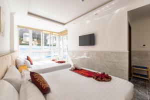 Postel nebo postele na pokoji v ubytování Nghia Lan Hotel