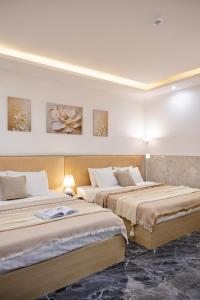 Postel nebo postele na pokoji v ubytování Nghia Lan Hotel