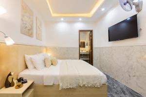 Postel nebo postele na pokoji v ubytování Nghia Lan Hotel