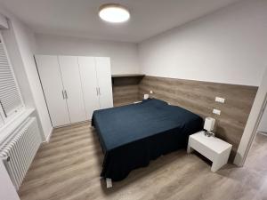 a room with a bed and a table in it at MARY Apartment in Tarvisio