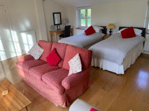 a living room with two beds and a couch at Field Cottage Bed and Continental Breakfast in East Harling