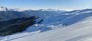 a snow covered slope with a ski lift on a mountain at Lodge Pizzo Alpestre in Abetone