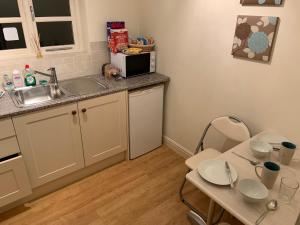 a small kitchen with a sink and a table at Field Cottage Bed and Continental Breakfast in East Harling +7 photos