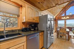 a kitchen with a stainless steel refrigerator and a dining table at Smoky Overlook in Sevierville +44 photos