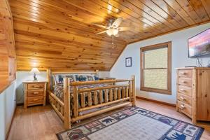 a bedroom with a bed and a wooden ceiling at Smoky Overlook in Sevierville