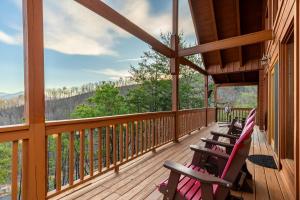 a porch with chairs and a view of the mountains at Smoky Overlook in Sevierville