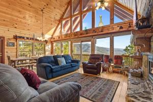 a living room with a couch and chairs and a fireplace at Smoky Overlook in Sevierville
