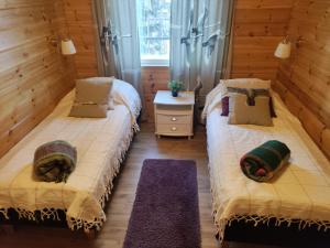Postel nebo postele na pokoji v ubytování Lake Cottage Onnenranta