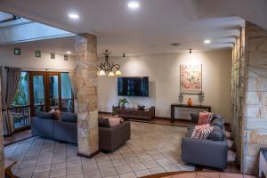 a living room with two couches and a flat screen tv at Pasteur Beautiful Luxury Home in Bandung