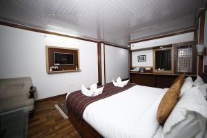 a bedroom with a large bed on a boat at Hotel Sikkim Tourist Centre in Pelling