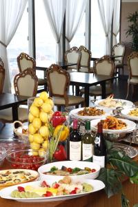 a table with plates of food and bottles of wine at 衣浦グランドホテル in Takahama