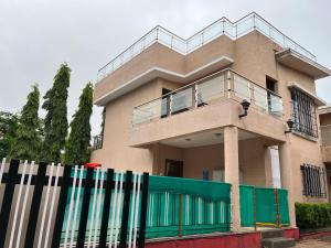 a house with a fence in front of it at Royal Villa 1 - Luxurious 2BHK Villa with Huge Pvt Swimming Pool in Lonavala