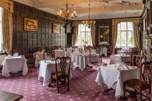 a dining room with white tables and chairs at Castle Bromwich Hall; Sure Hotel Collection by Best Western in Birmingham