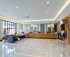 a lobby of a hospital with people sitting in a waiting room at d'primahotel Airport Sultan Hasanuddin Makassar in Sudiang