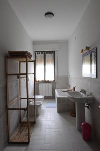 a bathroom with a sink and a tub and a toilet at L'Ortolano Apartments in Spoleto