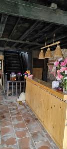 a restaurant with a counter with flowers on it at Mộc Nhiên Homestay in Sa Pa