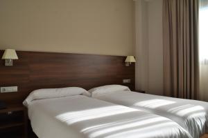 Postel nebo postele na pokoji v ubytování Hotel Pago del Olivo